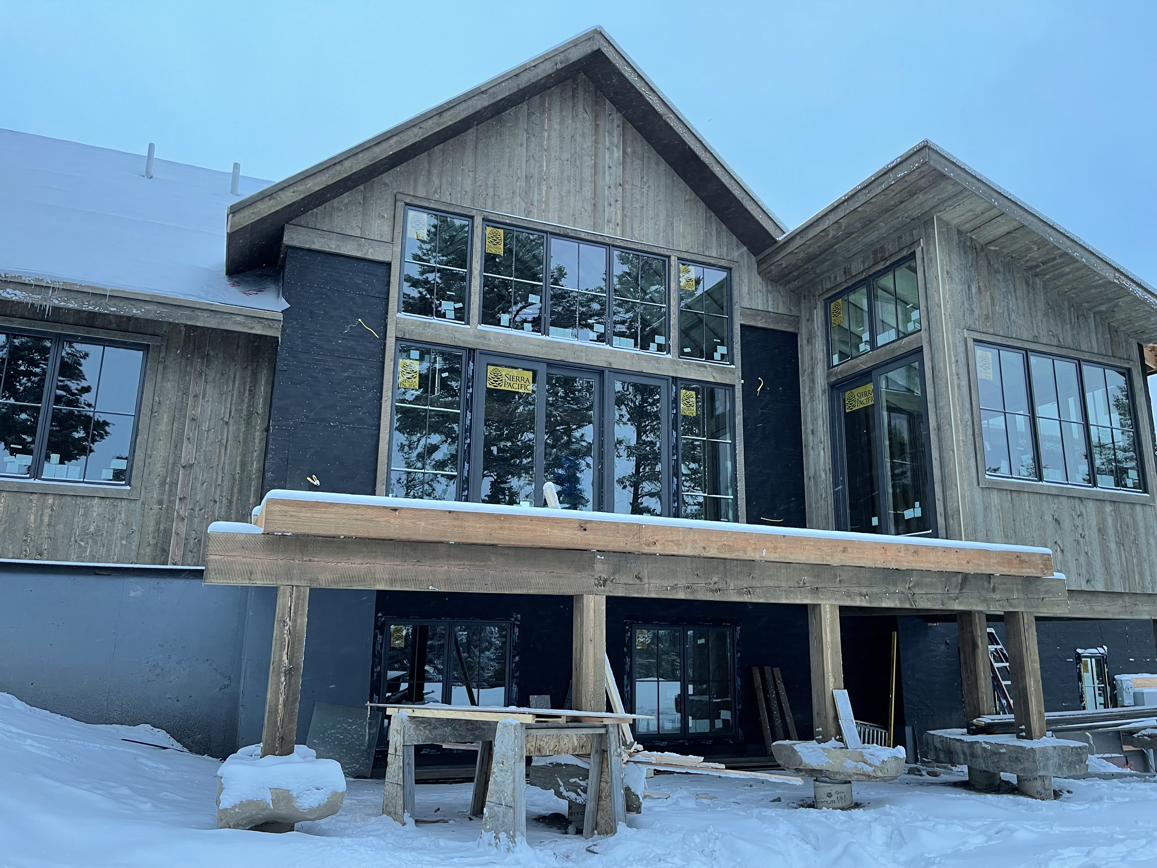 A house with a lot of windows in the snow