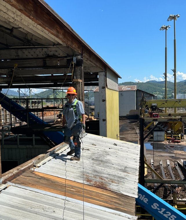 A man standing on top of a wooden ramp