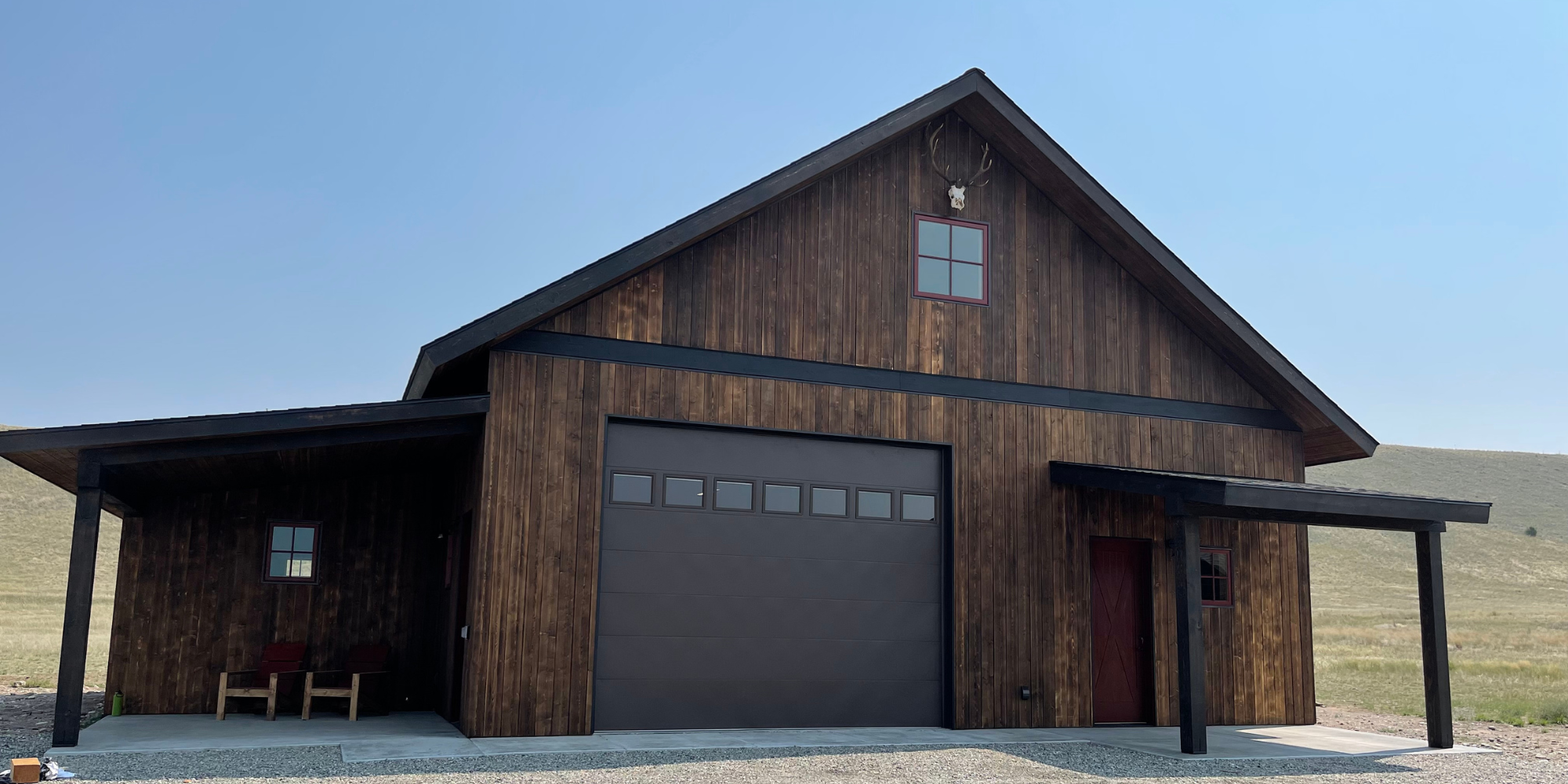 A large wooden building with two doors and a porch