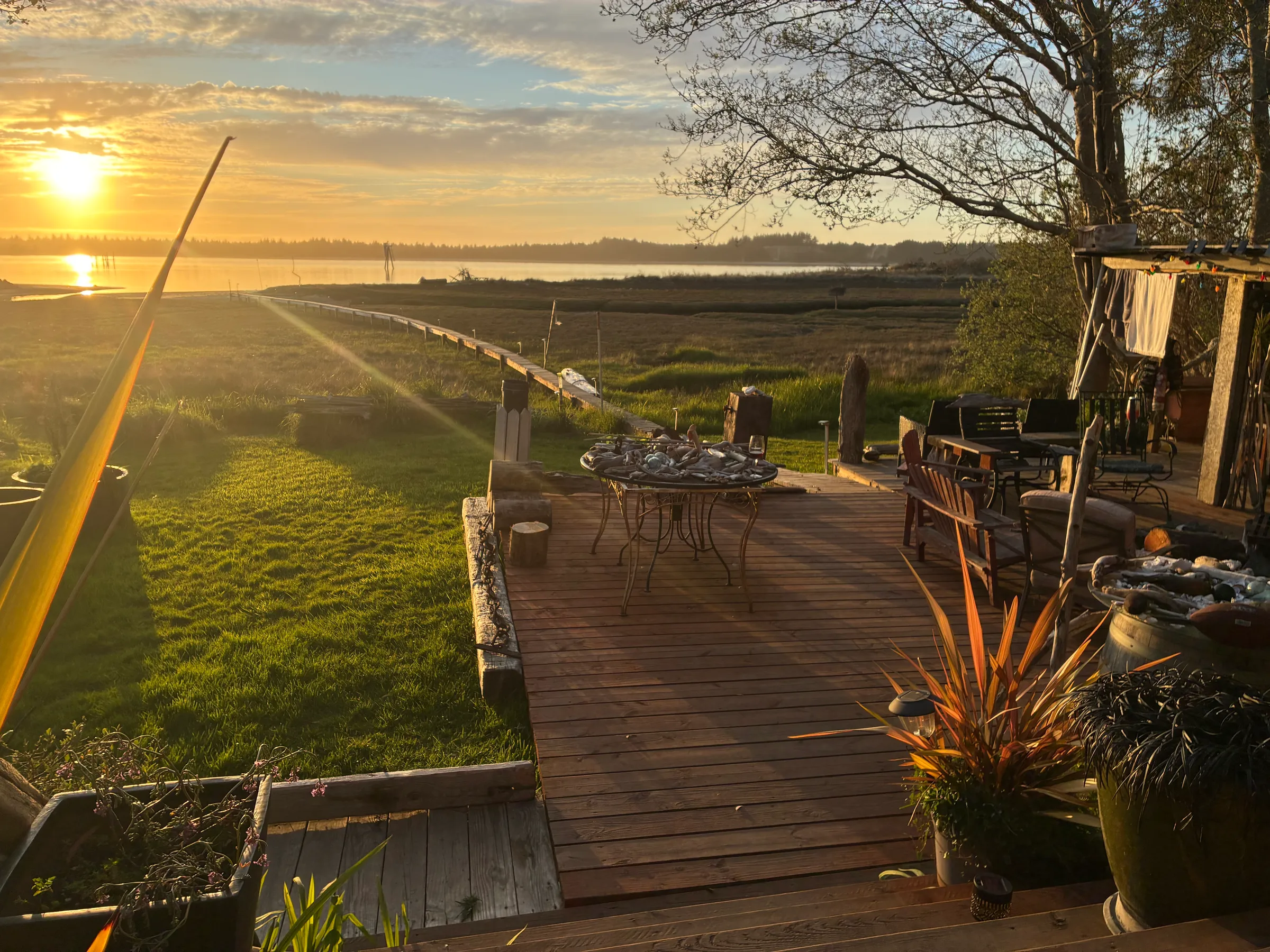 Waterfront deck with golden hour light over the bay
