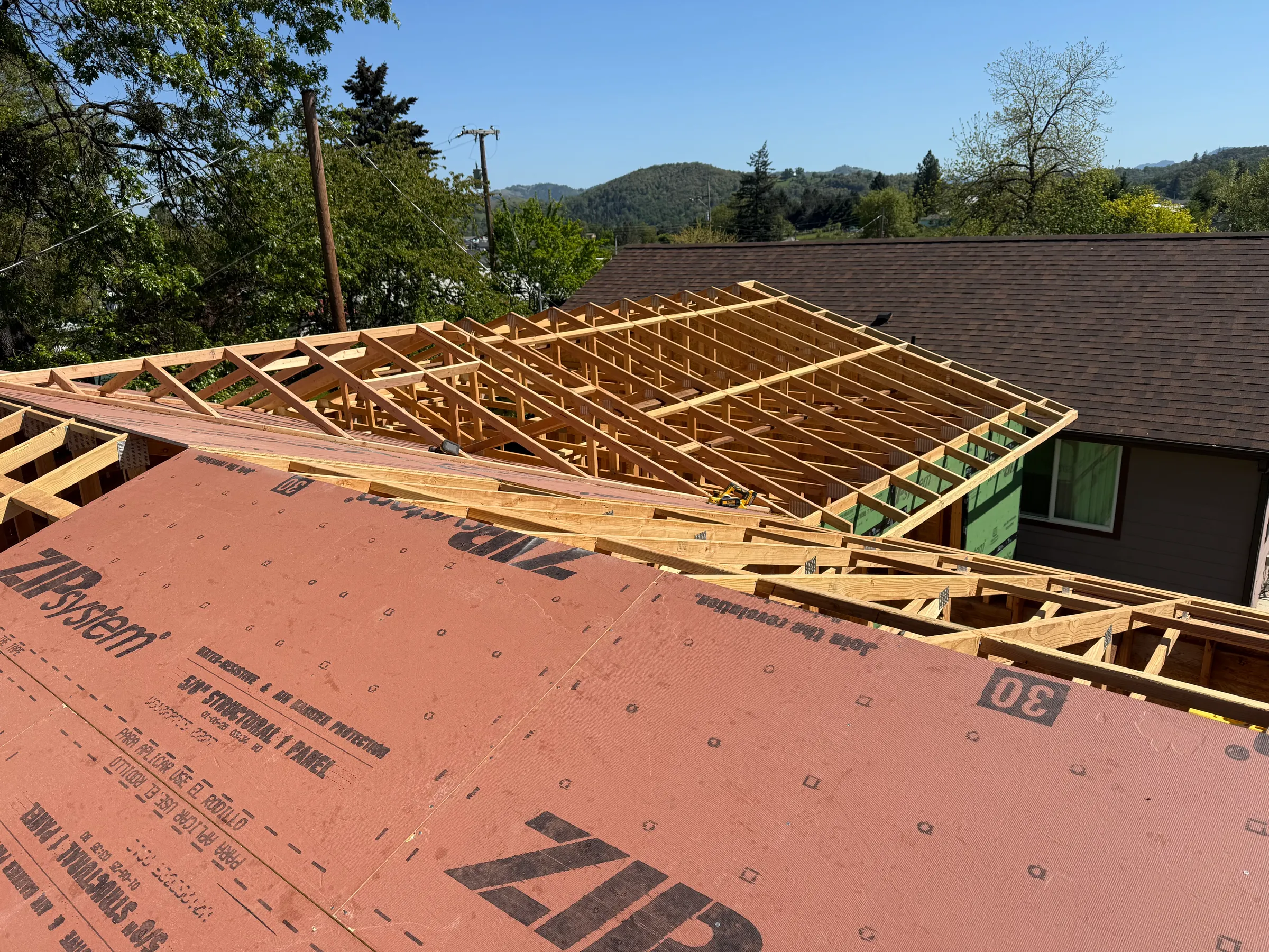 Roof framing in progress for a home addition